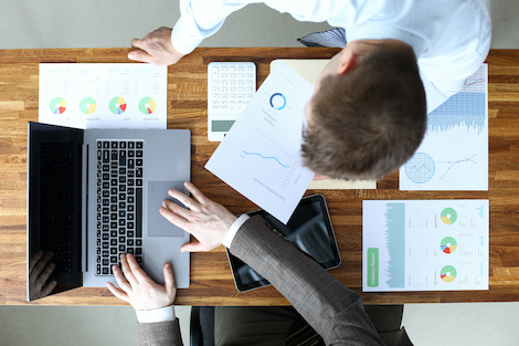 Professionals working at desk with laptop