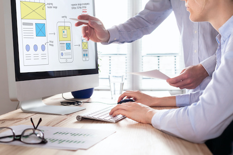 Website Designers wireframing on computer screen