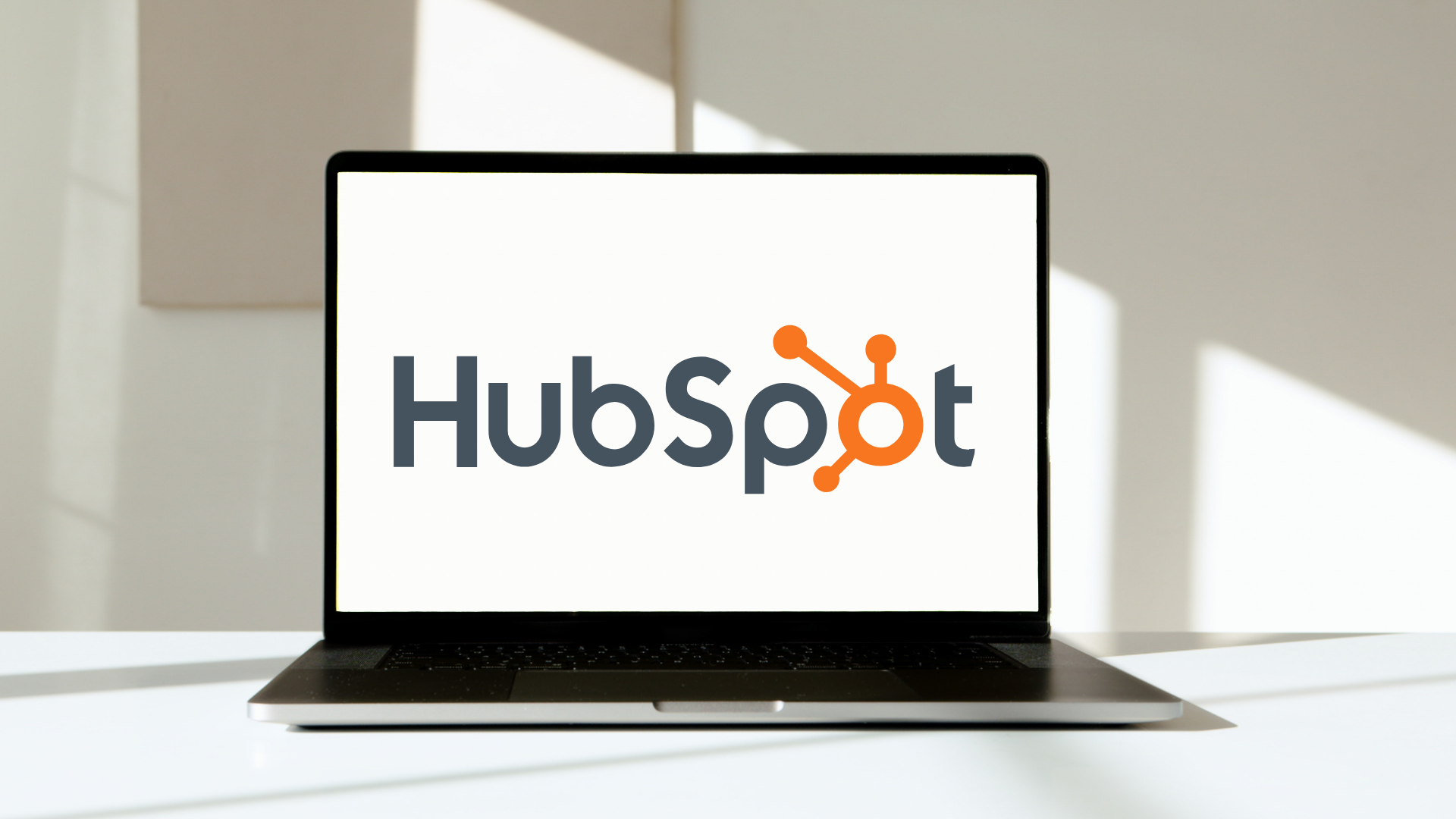 workspace with laptop screen showing HubSpot